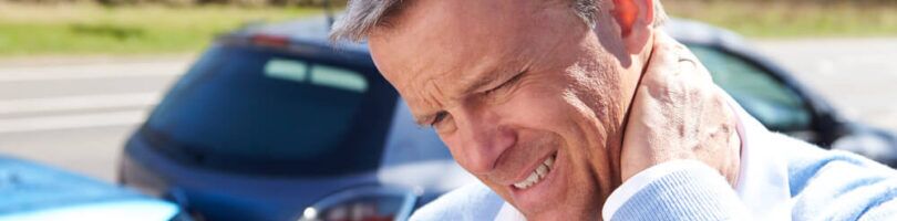 man holding his neck in pain after a rear-end collision